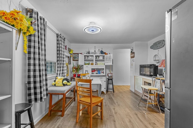 kitchen featuring light wood-type flooring and stainless steel fridge