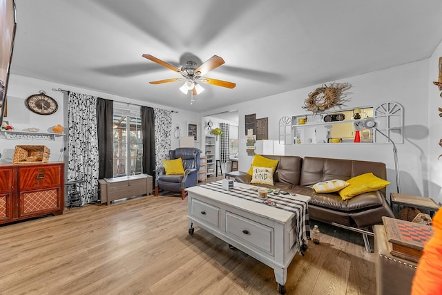 living room featuring ceiling fan and light hardwood / wood-style flooring