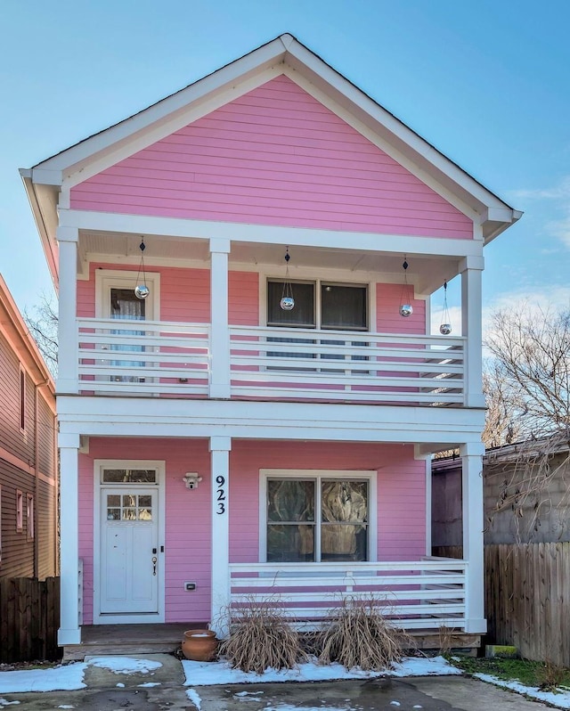 view of front facade with covered porch and a balcony