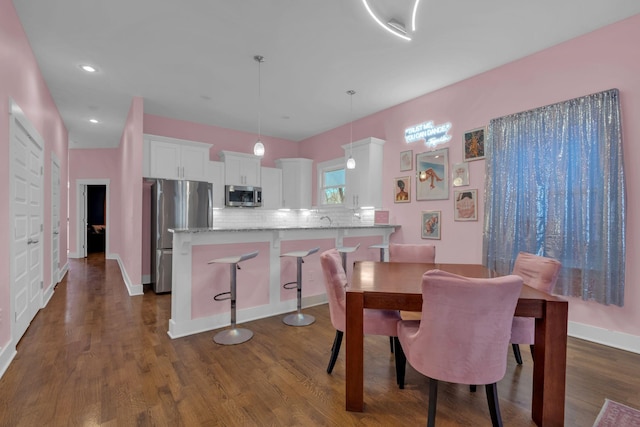 dining area with dark wood-type flooring