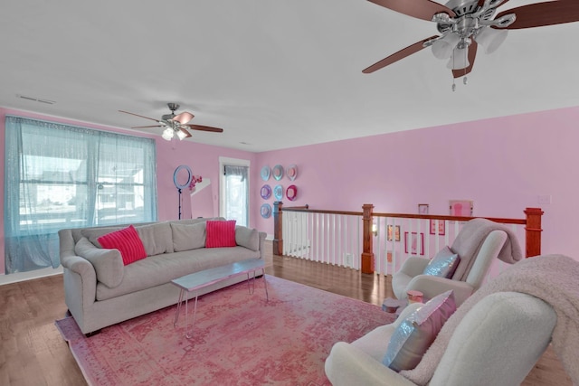 living room featuring light wood-type flooring and ceiling fan