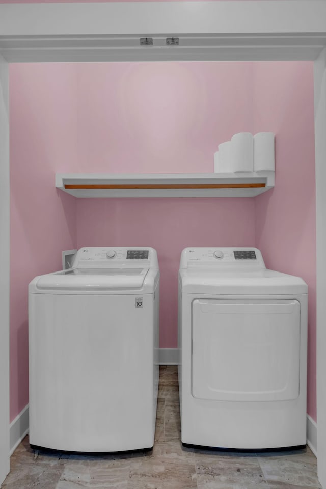 clothes washing area featuring washing machine and clothes dryer