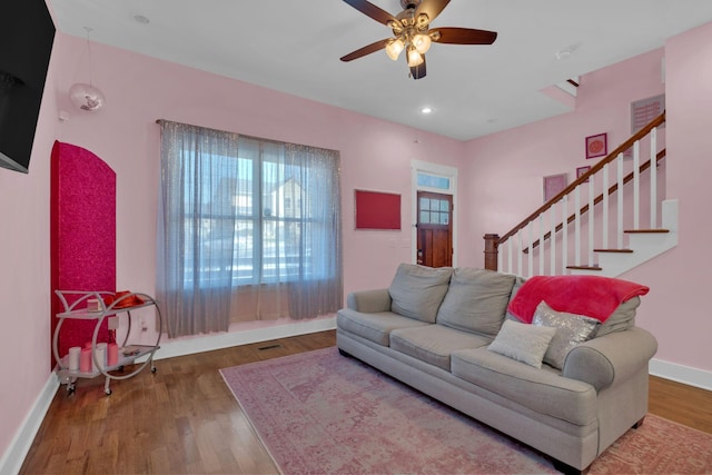 living room with ceiling fan and hardwood / wood-style flooring