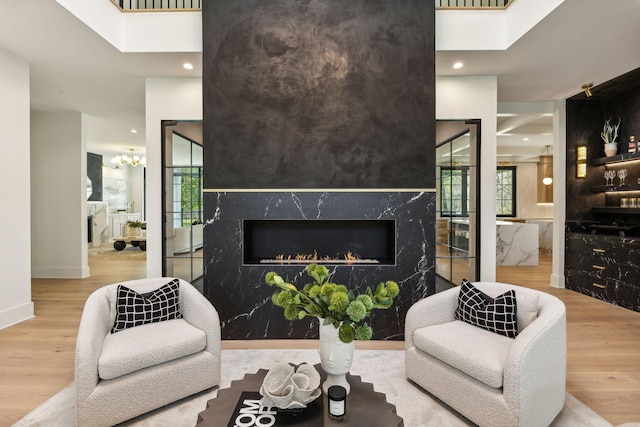 living room featuring hardwood / wood-style flooring and a high end fireplace