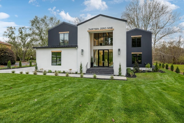 back of property featuring a lawn and french doors