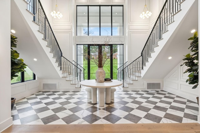 entrance foyer featuring french doors, a notable chandelier, and a high ceiling