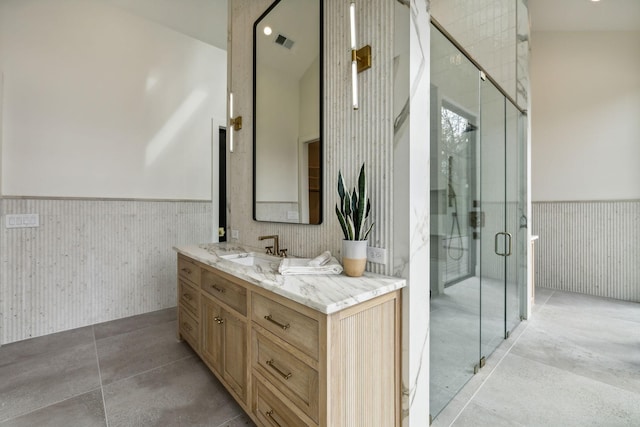 bathroom with an enclosed shower and vanity