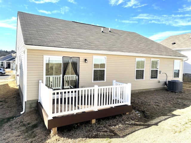 back of house with central AC unit