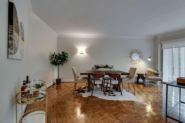 dining area with parquet flooring, ornamental molding, and a textured ceiling