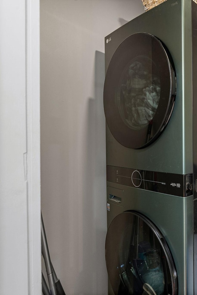 laundry area featuring stacked washer / drying machine