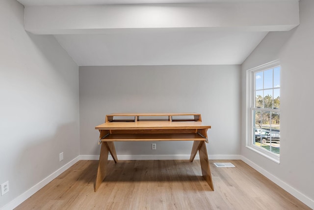 dining room featuring vaulted ceiling with beams, light wood-type flooring, and a wealth of natural light