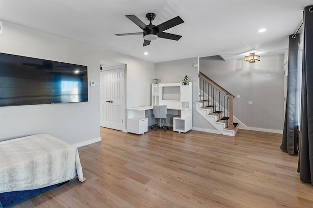 living room with ceiling fan and light wood-type flooring