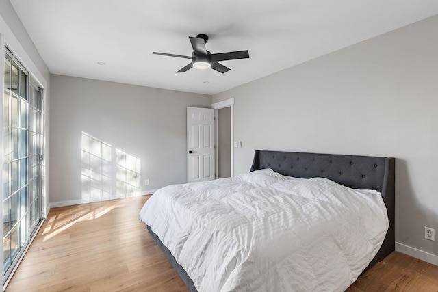 bedroom with ceiling fan and hardwood / wood-style flooring