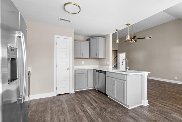 kitchen with sink, appliances with stainless steel finishes, gray cabinets, and kitchen peninsula