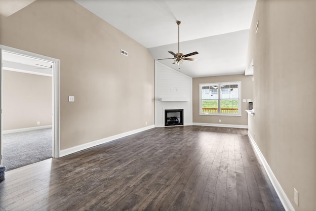 unfurnished living room featuring ceiling fan, a large fireplace, dark hardwood / wood-style floors, and high vaulted ceiling