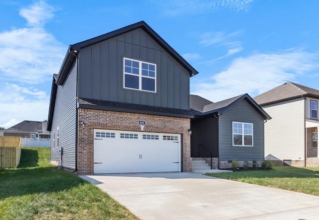 view of front of home with a front yard and a garage