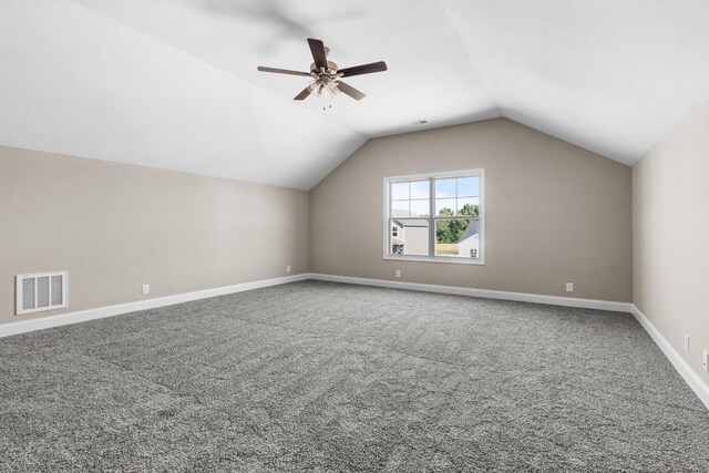 additional living space with ceiling fan, vaulted ceiling, and carpet flooring