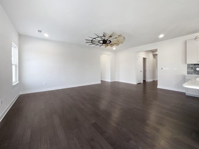 empty room featuring ceiling fan and dark hardwood / wood-style flooring