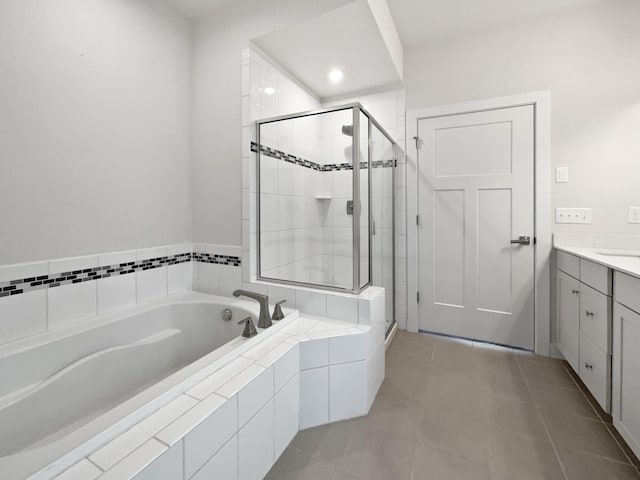 bathroom featuring tile patterned floors, vanity, and shower with separate bathtub