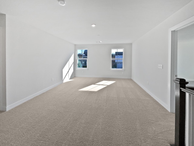 unfurnished living room featuring light carpet