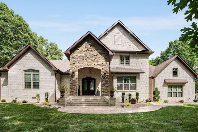 french country inspired facade featuring french doors and a front yard