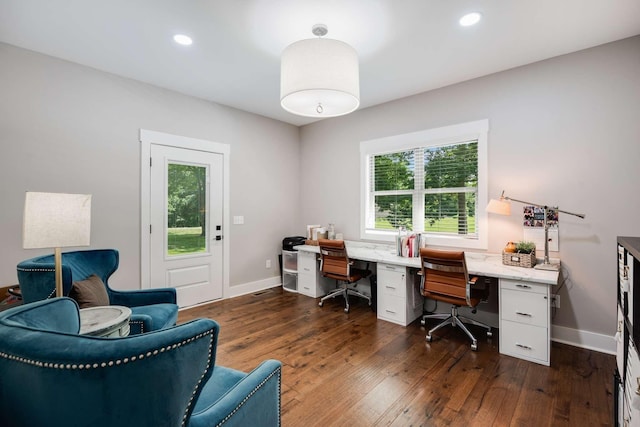 home office featuring a healthy amount of sunlight and dark hardwood / wood-style flooring