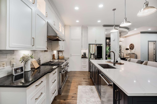 kitchen featuring hanging light fixtures, sink, white cabinetry, and stainless steel appliances