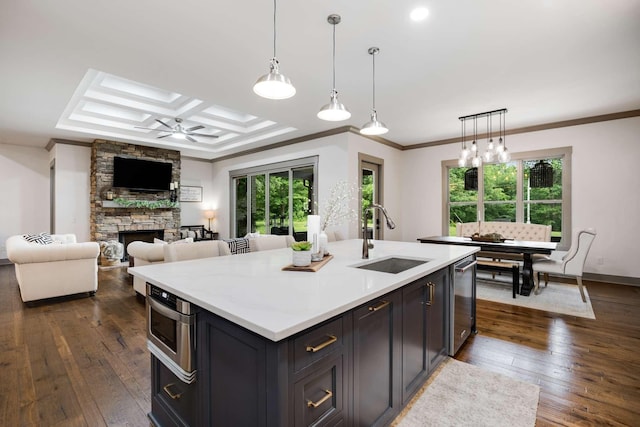 kitchen with pendant lighting, sink, dark hardwood / wood-style floors, ceiling fan, and coffered ceiling