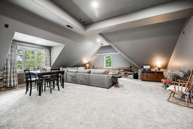 carpeted living room with lofted ceiling