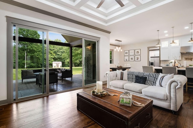 living room with ceiling fan, dark hardwood / wood-style floors, crown molding, and coffered ceiling