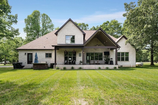 rear view of property with a yard and a patio