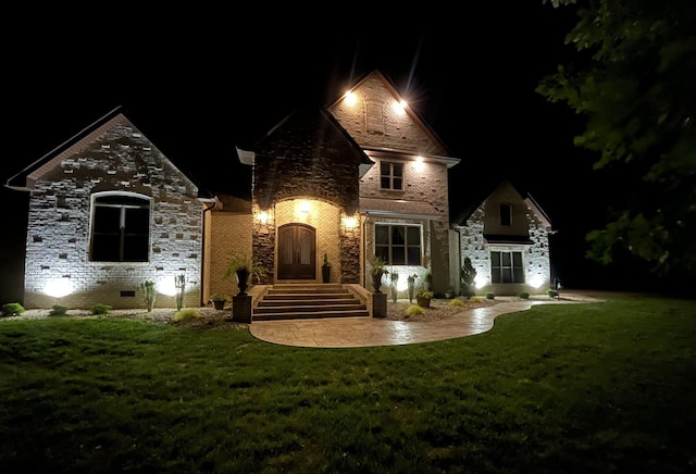 view of front of property with a patio area and a yard