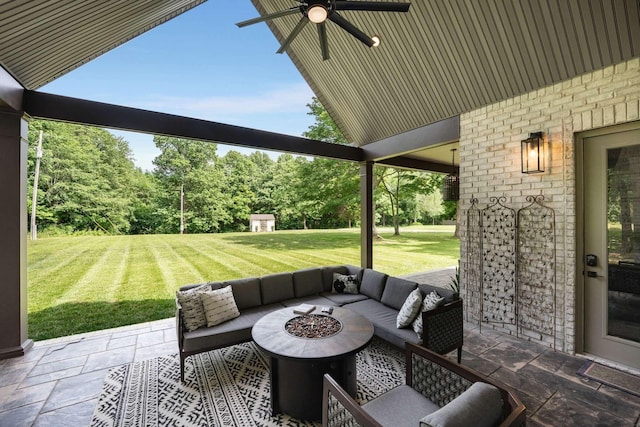 view of patio / terrace with ceiling fan and a fire pit