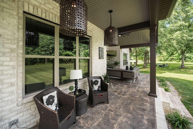 view of patio with ceiling fan and an outdoor living space