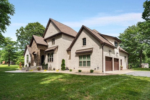 view of front of home with a garage and a front lawn