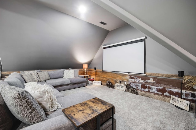 carpeted home theater room with lofted ceiling