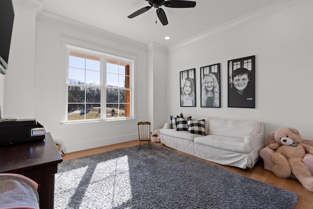 living room with ceiling fan, wood-type flooring, and crown molding