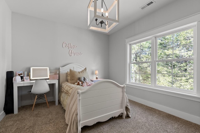 carpeted bedroom with a notable chandelier