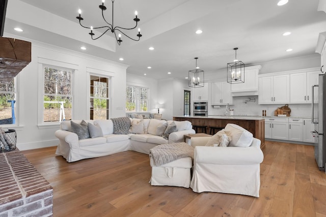 living room with light hardwood / wood-style flooring and ornamental molding