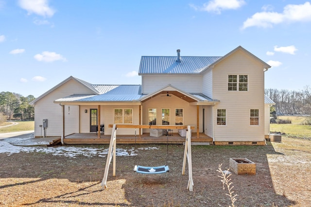 rear view of property with a deck and central AC