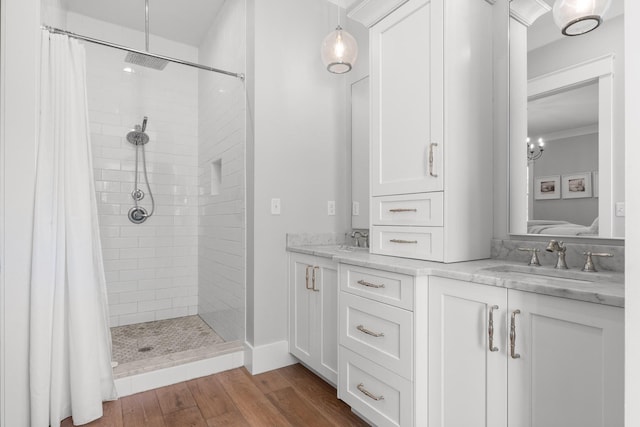 bathroom featuring curtained shower, hardwood / wood-style floors, vanity, and ornamental molding