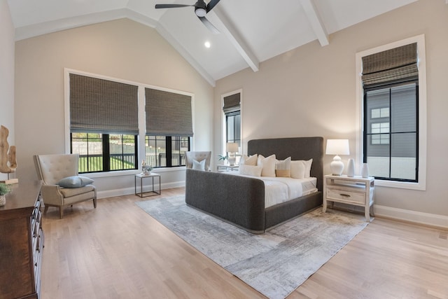 bedroom with ceiling fan, lofted ceiling, and light wood-type flooring