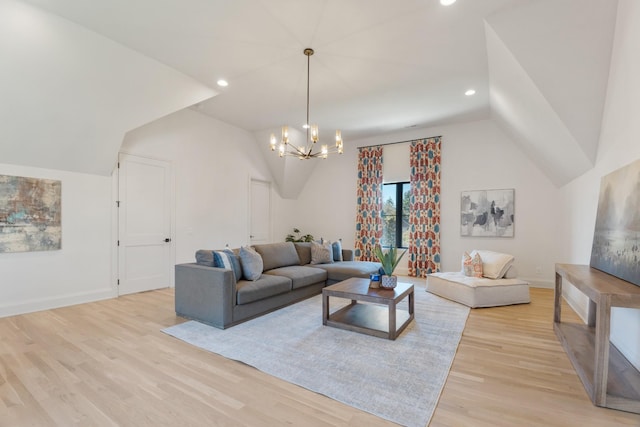 living room featuring an inviting chandelier, lofted ceiling, and light hardwood / wood-style floors