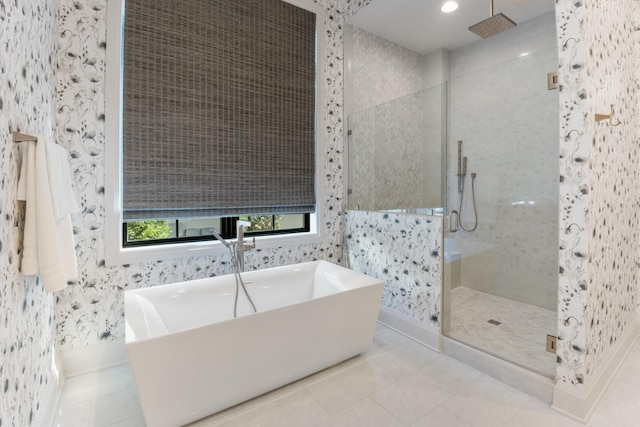 bathroom with separate shower and tub and tile patterned floors