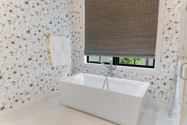 bathroom featuring tile patterned flooring and a bathtub