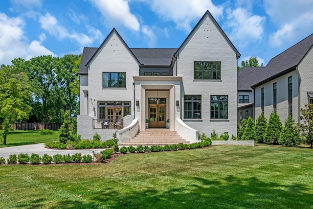 view of front of property with a front lawn and french doors