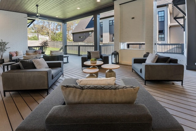 wooden terrace featuring ceiling fan and an outdoor living space