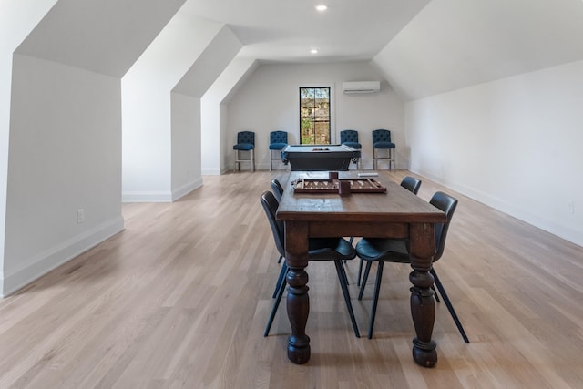 home office featuring pool table, light hardwood / wood-style flooring, a wall mounted AC, and vaulted ceiling