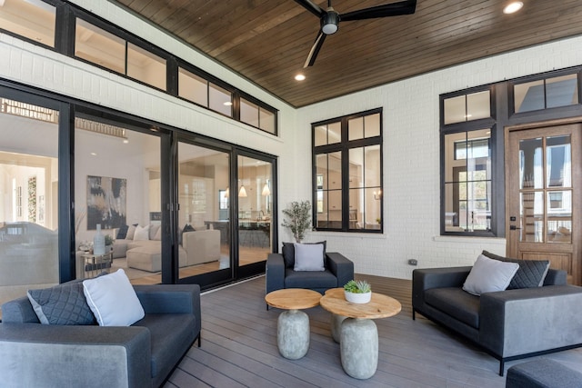 wooden deck featuring ceiling fan and an outdoor living space