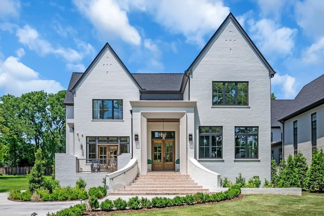 view of front of property featuring a front yard and french doors